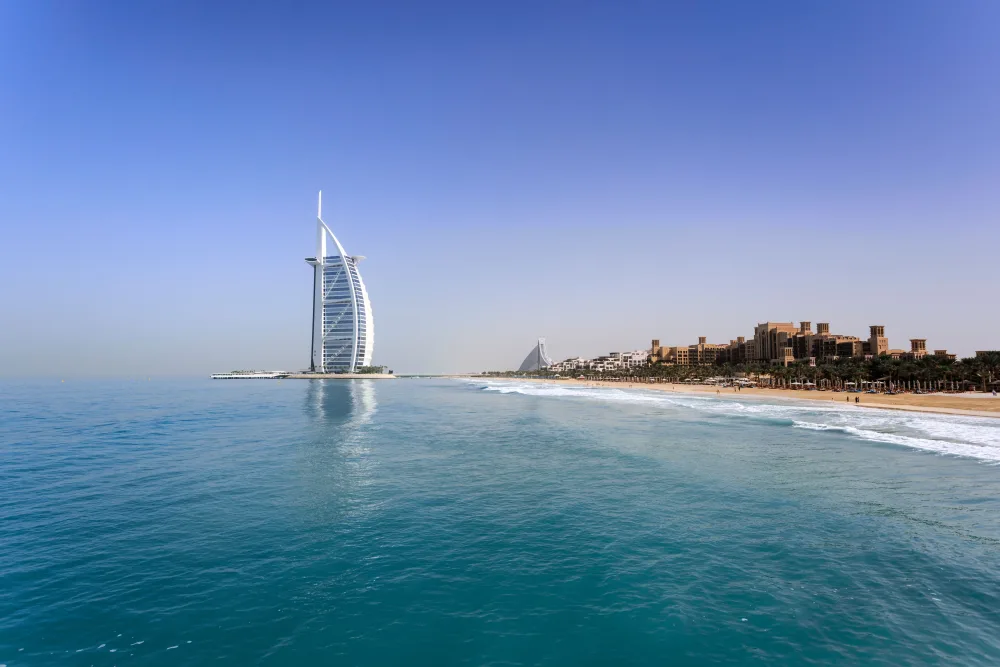 The sail-shaped Burj Al Arab hotel on the Dubai coastline, seen from the sea