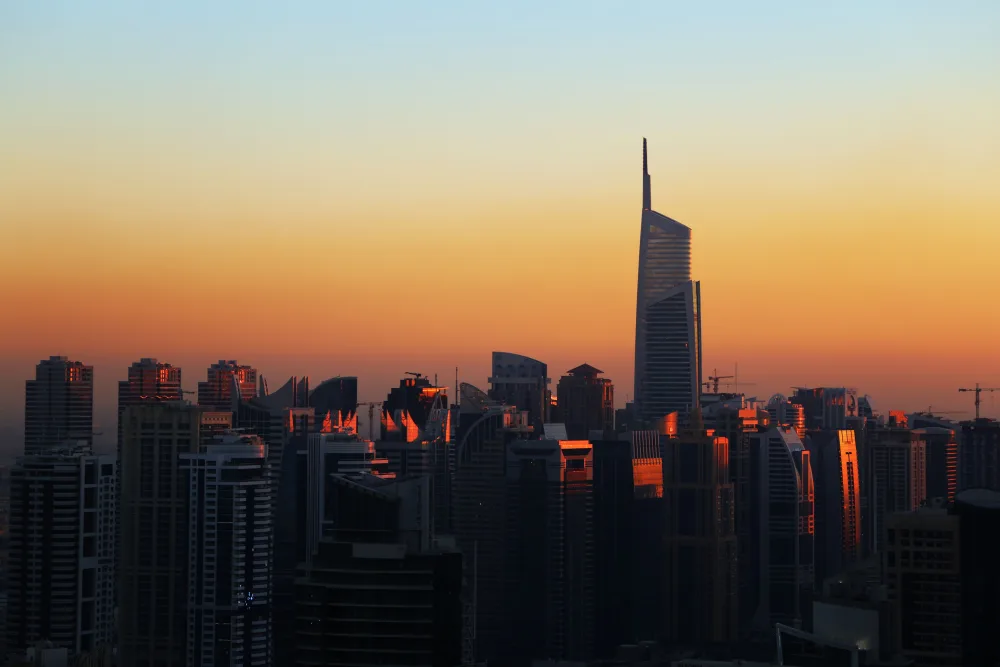 Skyscrapers of the Dubai Marina district lit by evening sunset light